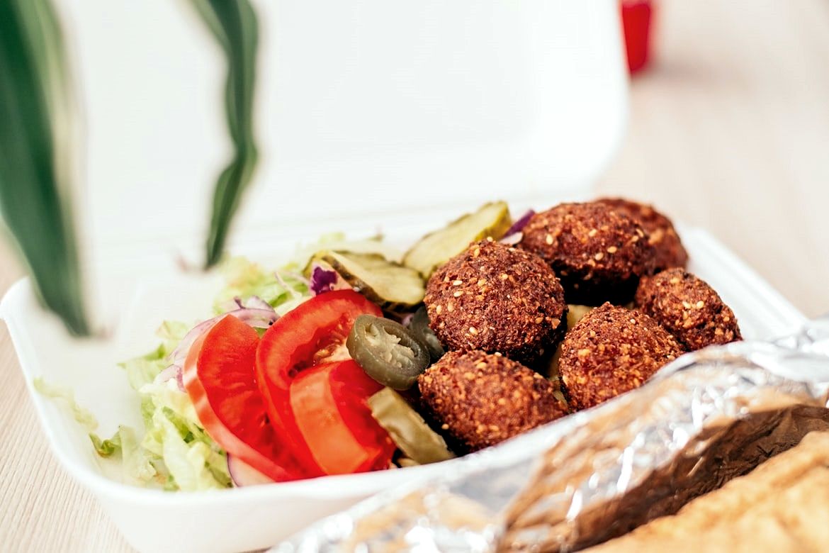 Falafels and salad in a takeout box