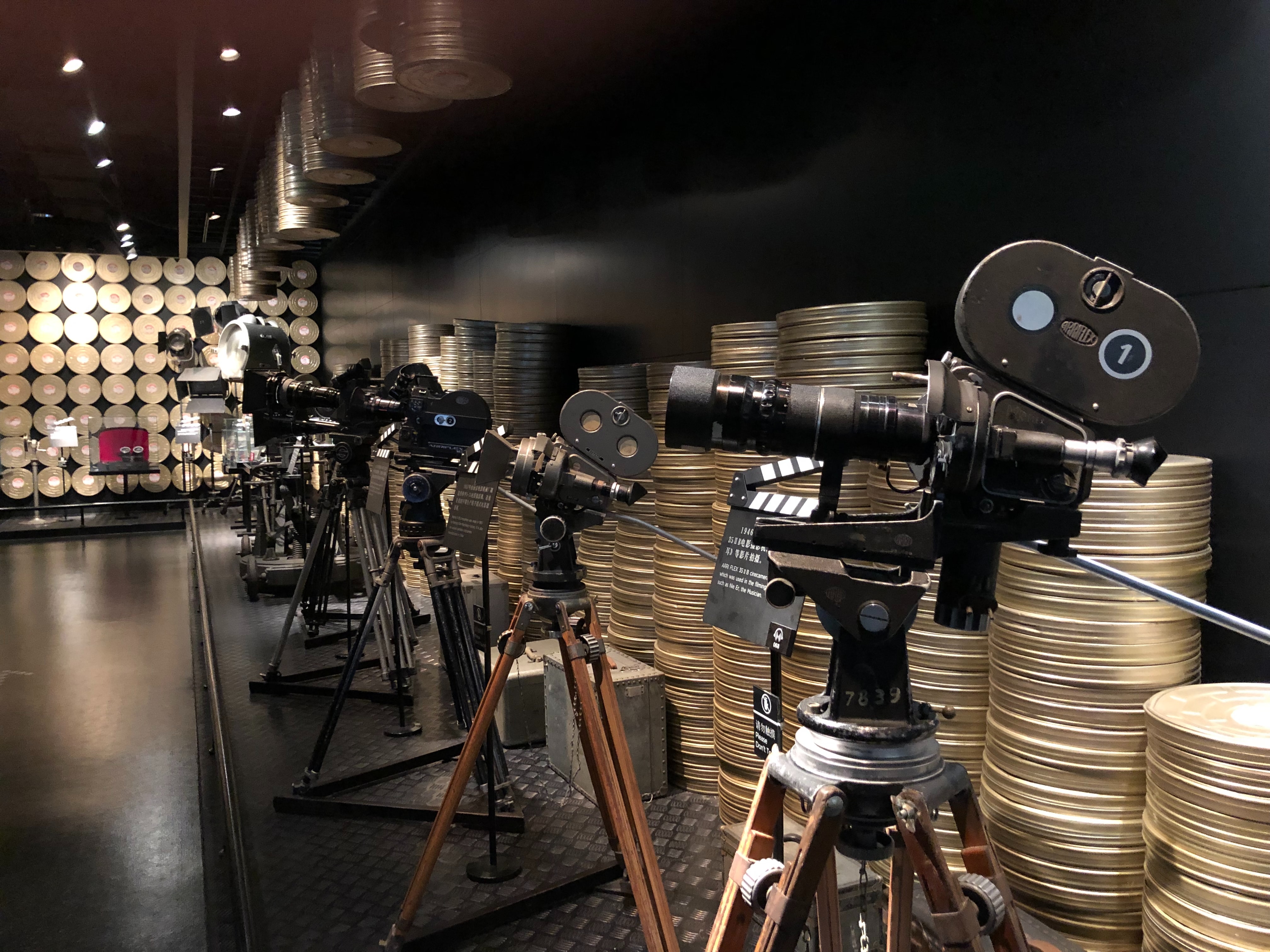 Black and silver cameras with film reels